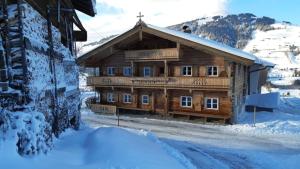 a wooden cabin in the snow with snow covered at Bauernhaus Brixen in Bichling