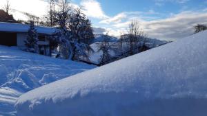 a pile of snow on the side of a house at Bauernhaus Brixen in Bichling