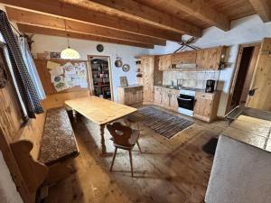 a kitchen with wooden floors and a wooden table at Lockner Hütte in Schwaigs +8 photos