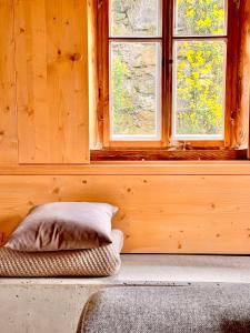 a wooden room with a pillow and a window at Neu Daserbhaus in Großschönau