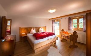 a bedroom with a large bed with a red blanket at Chalet Frauenkogel in Grossarl