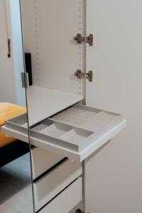 a cupboard with a white door with a drawer at Casa nicola- apt in the heart of Rome in Rome +70 photos