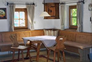 a dining room with a table and two chairs at Bergchalet Klausner Edelweiß in Ramsberg