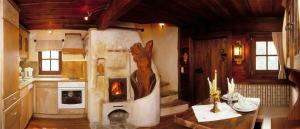 a kitchen with a fireplace in the center of the room at Bretei Hüttn in Unterberg +4 photos