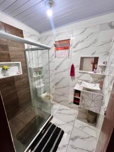 a bathroom with a shower and a sink at Casa Lagoa da Diva in Maricá +19 photos