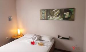 a bedroom with a white bed with a box on it at Hotel El Colibri Rojo - Le Colibri Rouge in Cahuita +46 photos