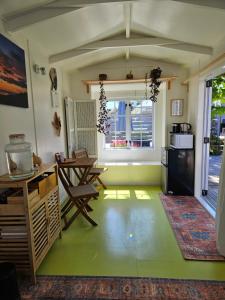 a kitchen with a table and chairs in a room at Zen Cabin in Mount Maunganui