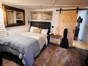 a bedroom with a bed and a guitar in it at Lakefront Getaway in Lone Oak