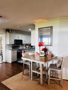 a kitchen with a table and a dining room at Lakefront Getaway in Lone Oak