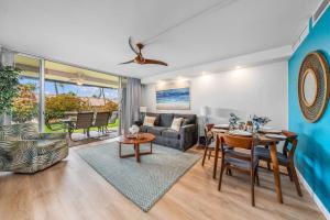 a living room with a couch and a table at Eldorado L102 · EL L102 Renovated 1BD Condo w Pool AC Beach Caba in Kahana