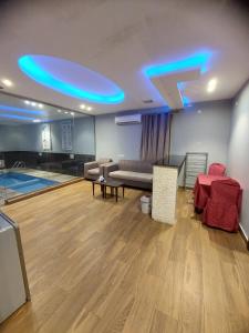a living room with blue lights on the ceiling at فندق دريم هاف in Jazan