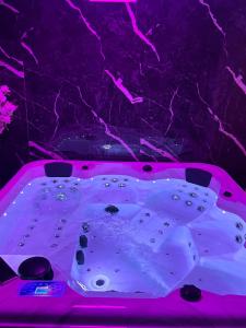 a pink table with rocks in a room with a purple ceiling at Dream Spa Jacuzzi&Sauna in Portet-sur-Garonne