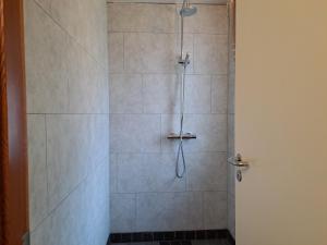 a bathroom with a shower with a glass door at Studlagil INN Hostel in Skjöldólfsstaðir +34 photos