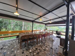 a dining room with a long table and chairs at The Simple Place - King and Twin in Klong Muang Beach