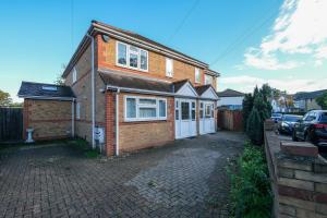a brick house on a brick driveway at Isher 3 Bedroom, 2-Bathroom House with Parking in Uxbridge