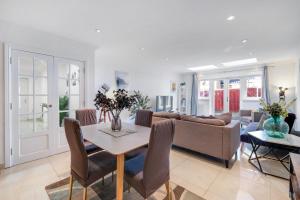 a living room with a couch and a table at Isher 3 Bedroom, 2-Bathroom House with Parking in Uxbridge