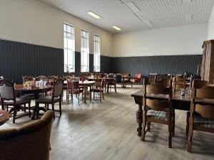 a restaurant with tables and chairs in a room at Studlagil INN Hostel in Skjöldólfsstaðir