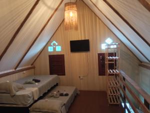 a room with two beds and a television in a tent at Chales Da Mata in Fortim +111 photos