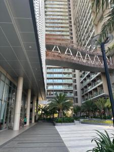 a large building with a walkway in front of it at The Sóng Homestay Vibes by the Sea in Vung Tau