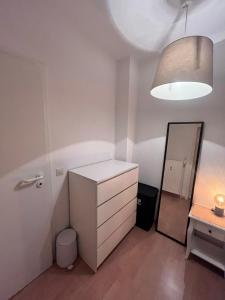 a small room with a white cabinet and a mirror at SH Apartments in Hannover