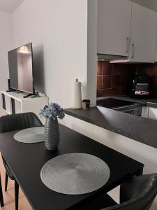 a kitchen with a table with a vase of flowers on it at SH Apartments in Hannover