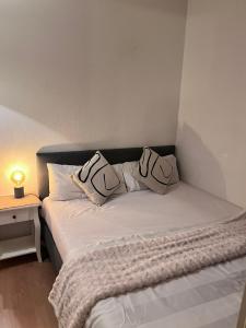 a bedroom with a bed with two pillows on it at SH Apartments in Hannover