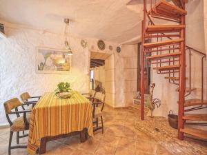 comedor con mesa y escalera de caracol en Holiday Home in LLevant with private pool, en Maria de la Salut