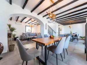 a dining room with a wooden table and chairs at Yoga and Relaxation Retreat in the Heart of Nature in Carratraca