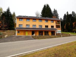 a large orange building on the side of a road at Dog-friendly holiday apartment in Bregenzerwald in Sibratsgfäll