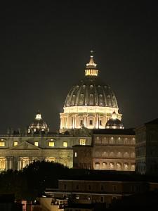 a large building with a dome at night at Vatican Stay Ottaviano in Rome