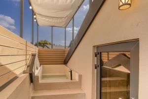 a building with stairs in front of a window at In Aewol Forest 201 in Jeju