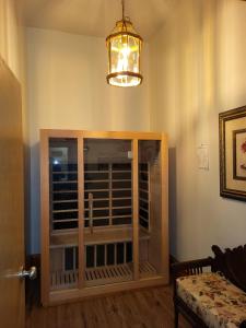 a room with a large window and a chandelier at Del Norte Colorado Stone Quarry Studio Apt in Del Norte