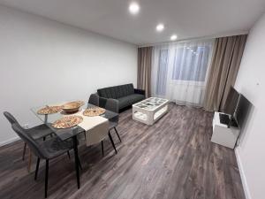 a living room with a table and a couch at Šarlot Apartment in Michalovce
