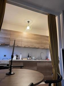 a kitchen with a table and aandelier at Prishtina Center Apartment in Pristina +4 photos