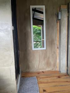 an empty room with a window and a rug at EB5 Escape Tzununa, Lake Atitlan Room #1 - two minute walk to the Lake in Santa Cruz La Laguna