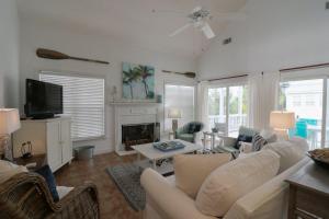 a living room with a white couch and a fireplace at #3 B 18th Place in Tybee Island