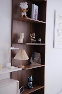 a book shelf with a lamp and other items on it at Winna Homestay - Nera Garden Huế in Thôn Văn Dương +26 photos