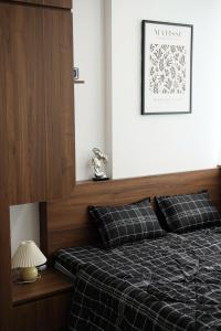 a bedroom with a bed with a black comforter at Winna Homestay in Thôn Văn Dương