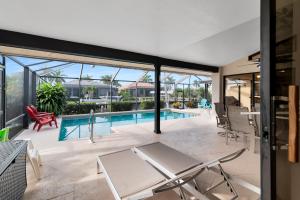 a house with a swimming pool and a patio at Pirates Cove Marco Island, saltwater pool, bikes, water sports, paddle boards included! in Marco Island