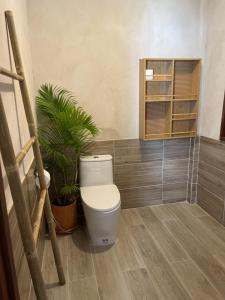 a bathroom with a toilet and a plant at À La Koh Kood Resort in Ko Kood +44 photos