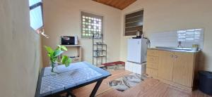 a kitchen with a table and a refrigerator at Casa Lara - Carmelitas Asunción in Asuncion