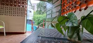 a vase sitting on a table with a plant at Casa Lara - Carmelitas Asunción in Asuncion
