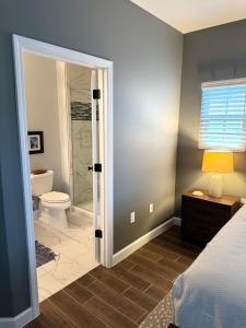 a bedroom with a bathroom with a shower and a toilet at The Pensacola Retreat-Spacious, pet-friendly home in Pensacola