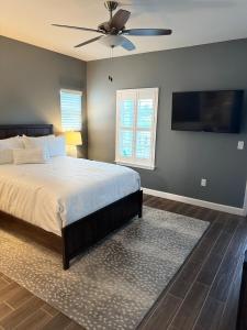 a bedroom with a bed and a ceiling fan at The Pensacola Retreat-Spacious, pet-friendly home in Pensacola