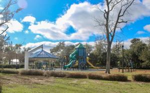 a playground with a slide in a park at The Pensacola Retreat-Spacious, pet-friendly home in Pensacola
