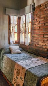 サンタ・ロサ・デ・カラムチタにあるcabañas Samay-Piskhoのベッドとカーテンのついた窓のある寝室