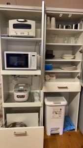 an open refrigerator with a microwave and other appliances at オシドリ in Shirahama +8 photos