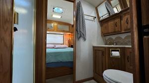 a small bathroom with a bed and a toilet at Retro Star-Wagon, Ocean View at Studios in Oceanside