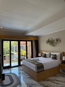 a bedroom with a large bed and a balcony at Mara inn in Nusa Dua +49 photos