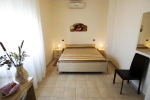a bedroom with a bed and a desk and a chair at Il Pentagono in Termoli +117 photos
